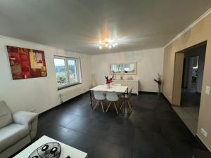 a living room with a table and a couch at Green escape - Sunset & nature in Boevange-sur-Attert