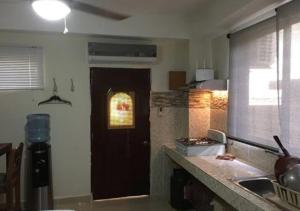 a kitchen with a door with a window and a counter at Apart-Hotel Costa Verde in Costa Verde +27 photos