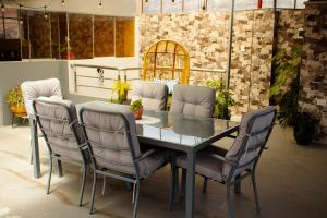a dining room table with four chairs around it at Ayllu in Huaraz