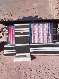 a group of windows on a building in the desert at Wadi Rum Ali Camp &Tours in Wadi Rum