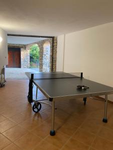 a ping pong table in the middle of a room at La Corte di San Rocco in Murazzano