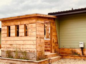 a wooden building next to a house at Little Eden Country Park, Bridlington with Private Hot Tubs in Bridlington