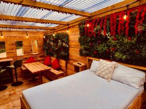 a bedroom with a bed in a room with plants at Little Eden Country Park, Bridlington with Private Hot Tubs in Bridlington