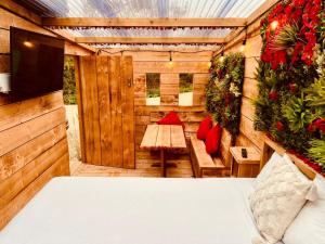 a room with a bed and a table and a television at Little Eden Country Park, Bridlington with Private Hot Tubs in Bridlington +179 photos