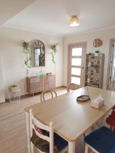 a dining room with a table and a mirror at Casa Centinela in Antequera