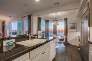 a large kitchen with a view of the ocean at Surf House in Encinitas +36 photos