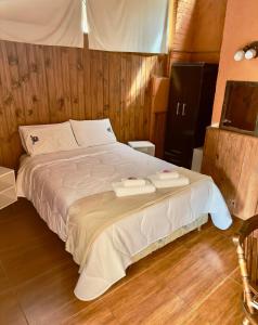 a bedroom with a bed with two trays on it at Casa Calamo Hotel in Treinta y Tres