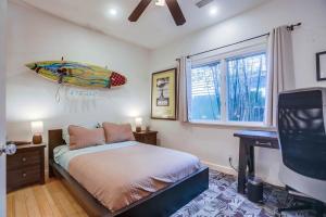 a bedroom with a bed with a surfboard on the wall at GrandView in Encinitas +36 photos