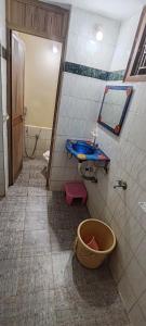 a bathroom with a blue sink and a toilet at Nakwa's mansion in Malpe
