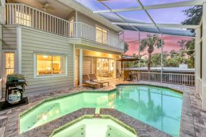 a swimming pool in front of a house at Villa Champagne - 5322 in Siesta Key