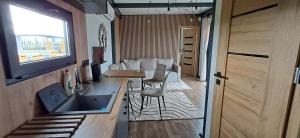 a kitchen with a sink and a table in a room at DuoDomkyTa3 in Spišská Belá