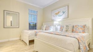 a bedroom with two beds and a window at Casa Antilles - 1036L in Siesta Key +42 photos
