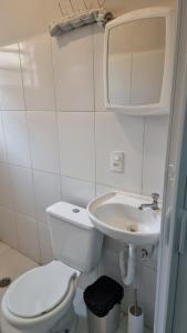 a white bathroom with a toilet and a sink at Hotel Parque Mamed in Diadema +52 photos