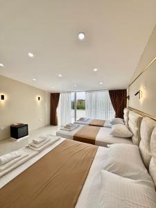a large bedroom with three beds and a television at Hagia Sophia Place Hotel in Istanbul