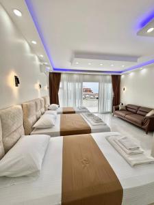 a bedroom with three beds and a couch at Hagia Sophia Place Hotel in Istanbul