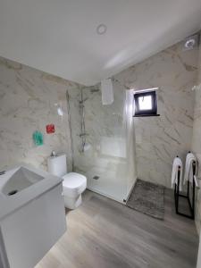 a bathroom with a toilet and a shower and a sink at CiTY CENTER in Monte +57 photos