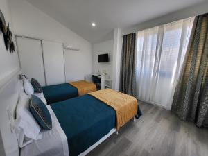 a hotel room with two beds and a window at CiTY CENTER in Madalena