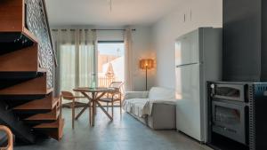 a kitchen and living room with a refrigerator and a table at Villa sunset piscina privada in Luque