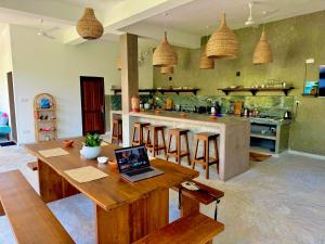 a kitchen with a table with a laptop on it at CoCo-SuRf-House, Luxury among palms in Hikkaduwa
