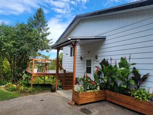 a porch of a house with a deck at The House On The Lake in Ferme-Neuve