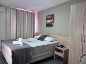 a bedroom with a bed with a pink lighting at Executivo Prime Hotel in Teresina +31 photos