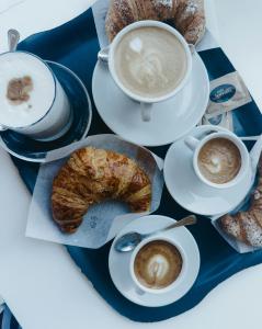 a table with two cups of coffee and some pastries at Domu Jole B&B in Selargius
