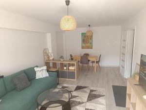 a living room with a green couch and a table at 2-room apartment, central & quiet in Gdynia