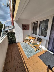 a patio with two chairs and a table on a balcony at 2-room apartment, central & quiet in Gdynia +8 photos