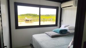 En eller flere senge i et værelse på Modulo do Plátanos