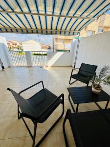 a room with two chairs and a table on a balcony at Casa Margarita in San Pedro del Pinatar