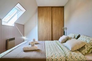 a bedroom with a bed with two towels on it at La Halte Verte - Garden -Wifi - Near Lille in Ennevelin