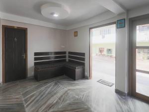 a room with a bench in the middle of a room at Collection O Police Bazar Shillong Formerly Pillars House in Shillong