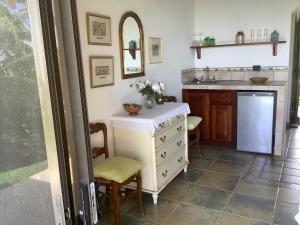 a kitchen with a white dresser and a sink at PRIVATE SPACE Just you and the Birds with PRIVATE INFINITY POOL in Uvita