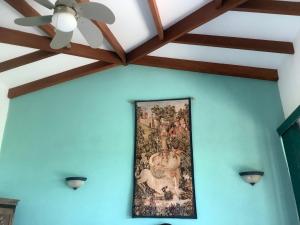a painting on a wall with a ceiling fan at PRIVATE SPACE Just you and the Birds with PRIVATE INFINITY POOL in Uvita