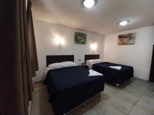 Ένα ή περισσότερα κρεβάτια σε δωμάτιο στο Hotel Las Gardenias +4 φωτογραφίες