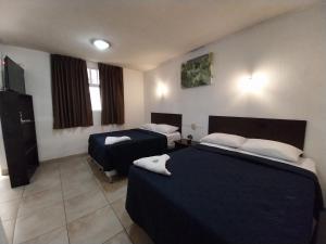 Ένα ή περισσότερα κρεβάτια σε δωμάτιο στο Hotel Las Gardenias