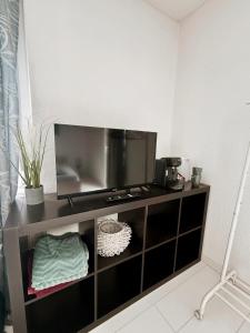 a tv on a shelf in a room at P&S Home in Nordstemmen +10 photos