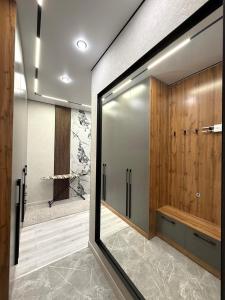 a bathroom with a shower and a sliding glass door at Жилой комплекс Космос in Bishkek