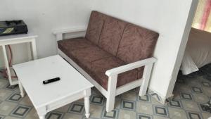 a chair and a side table in a room at Savannah Apartments in Narok