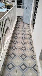 a hallway with a tiled floor and a staircase at Savannah Apartments in Narok
