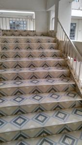 a staircase in a building with a tile floor at Savannah Apartments in Narok