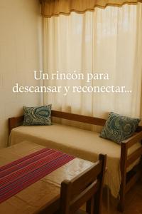 two beds in a room with the words unuminati pantera desasyasy respondent at Lavanda y Romero in Villa Yacanto