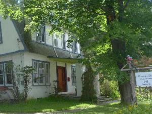 a white house with a tree in front of it at Morning Glory B&B Woodstock NY in Woodstock