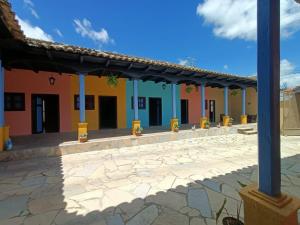a row of colorful buildings with a patio at Jazmin Hotel Boutique Colonial in Comitán de Domínguez