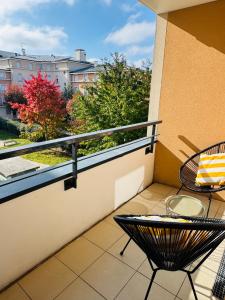 a balcony with a table and chairs on a balcony at Proche Disney Paris Appartement cosy et familial pour 4 Pers-Wifi-Parking Privé in Bussy-Saint-Georges +21 photos