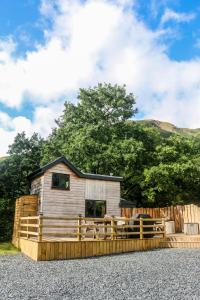 a house with a wooden fence in front of it at Ty Nant Cafn in Machynlleth
