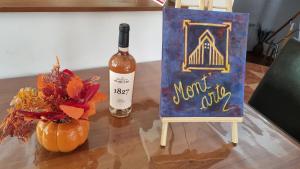 a bottle of wine sitting next to a painting and a bottle of wineozy at Mont'Arte - Private Art retreat Villa in Buşteni