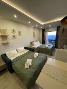 a hotel room with two beds and a couch at Apartman TAUNUS in Kopaonik +50 photos