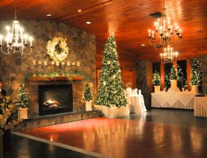 a living room with a fireplace and a christmas tree at Stroudsmoor Country Inn in Stroudsburg +60 photos