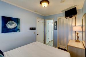 a bedroom with a bed and a flat screen tv at SC309A: 309A Sea Cabin in Isle of Palms +16 photos